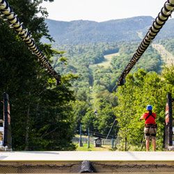Spring zip line brake absorbing rider momentum